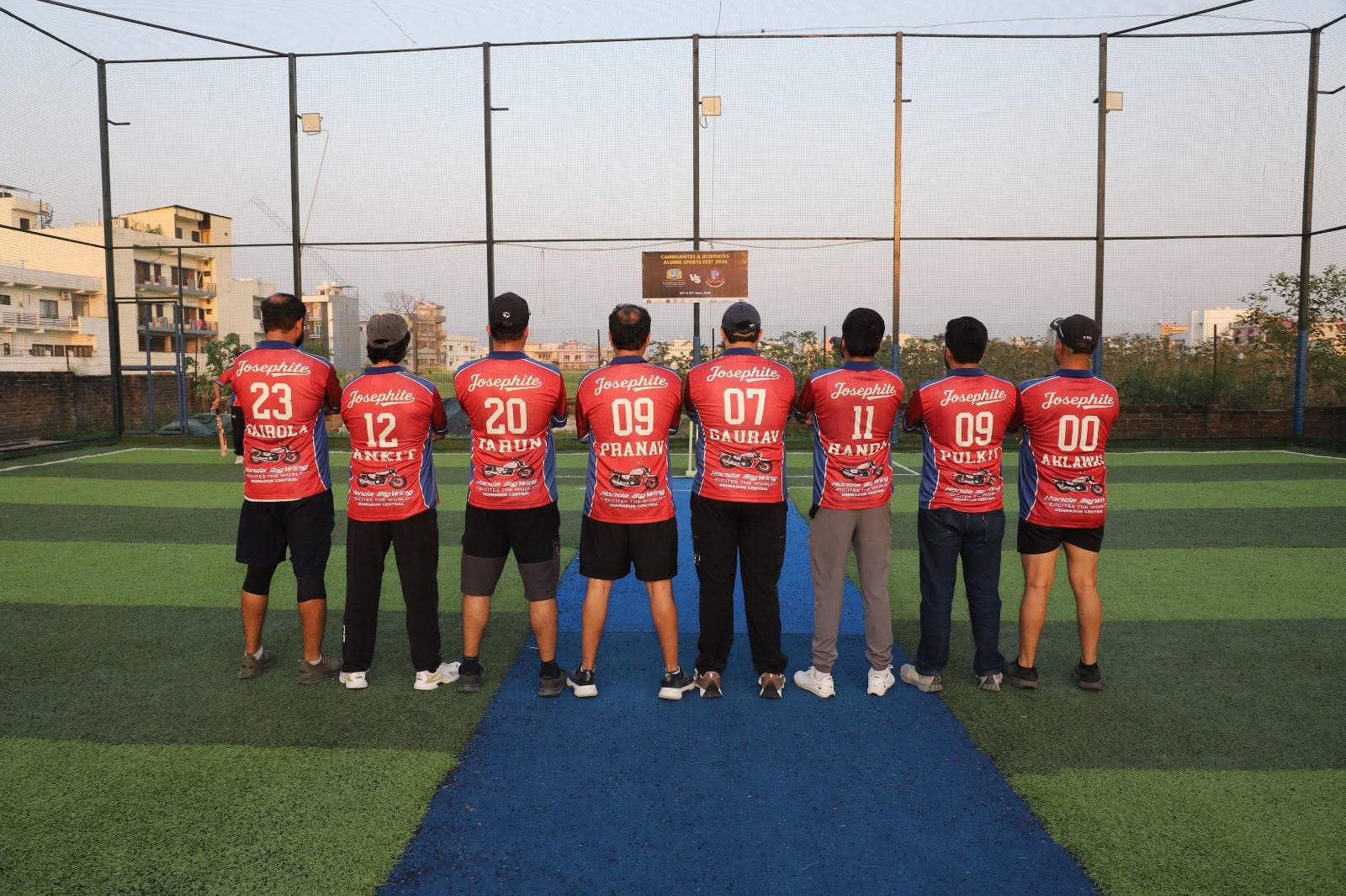 Josephites wearing matching red team jerseys on a sports turf